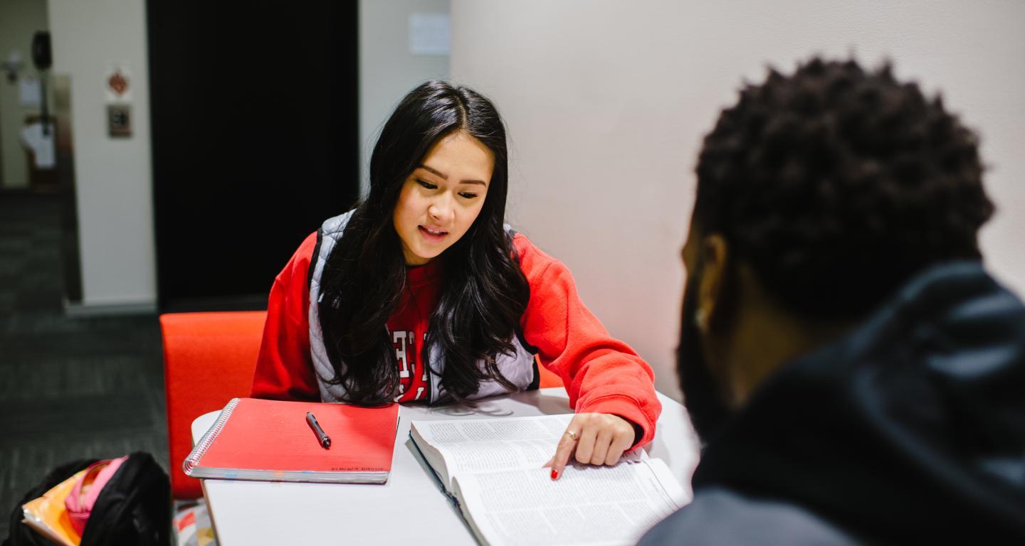 students looking at notes, studying