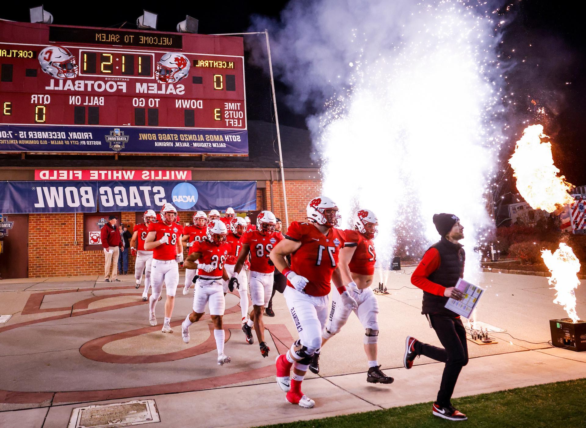 The North Central football team runs out on the field for the Stagg Bowl.