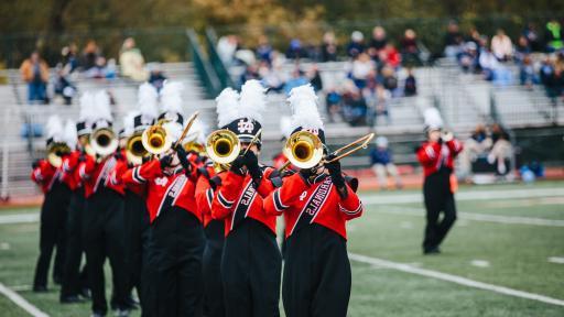 Marching band performing at football game